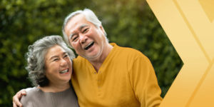 An older couple smiles, learning how to stay healthy with the help of Medicare coverage